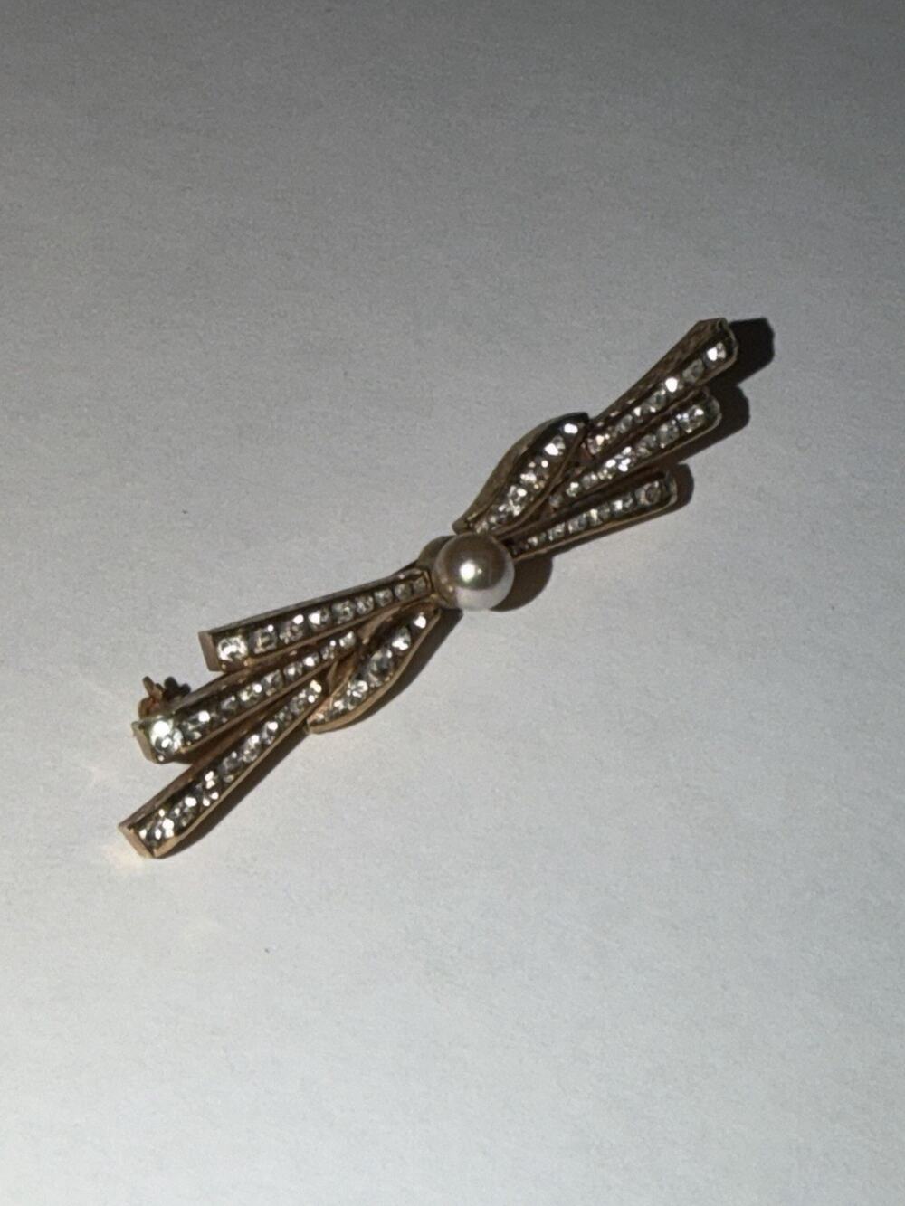 Vintage Gold Tone Bow Brooch With Rhinestones And Pearl Accents